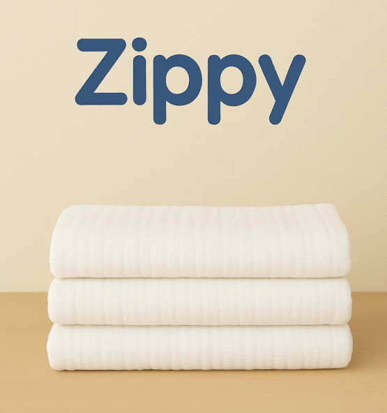 "Zippy soft muslin burp cloths in white and pastel colors, folded and stacked for newborn care"